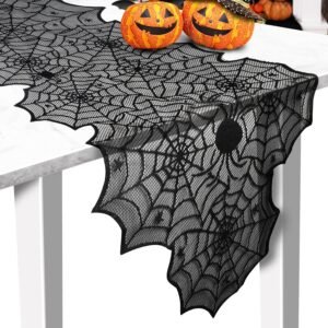 black lace spider web Halloween table runner with pumpkins on marble table