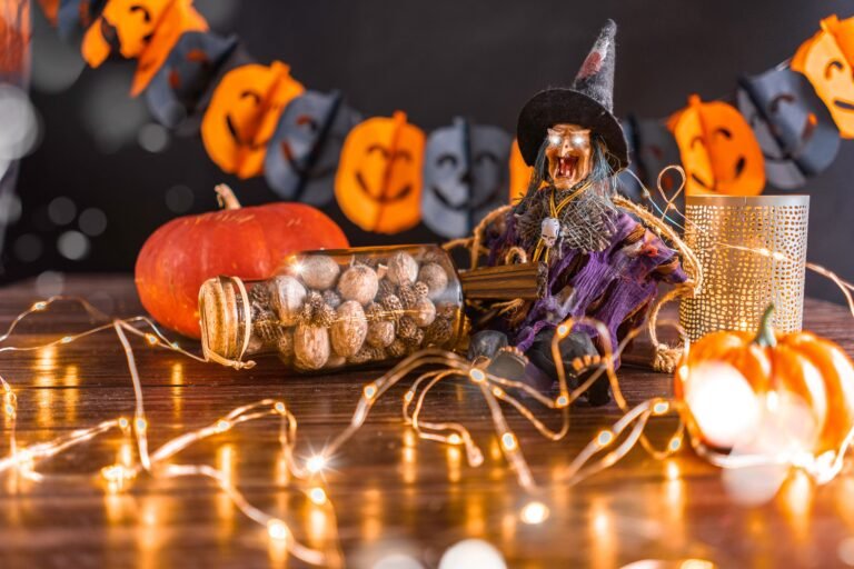 Energy Efficient Halloween Lights: The Real 92% Stat Battery Users Miss 4 Halloween tabletop display with a witch figurine with glowing eyes, a pumpkin, string lights, and a jack-o'-lantern garland